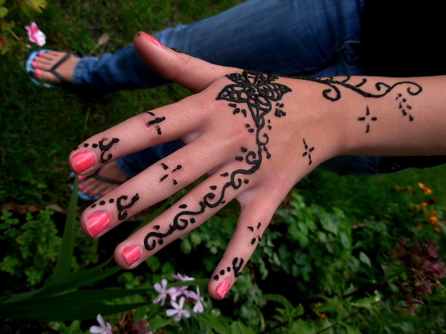 Girl showing her henna tattoo on left hand