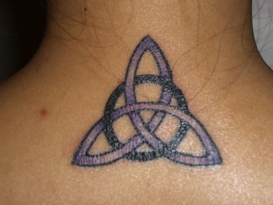 Purple-and-black-Celtic-design-tattoo-behind-the-neck